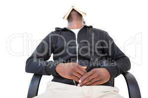 Man sleeping in swivel chair with book over face