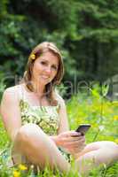 Relaxed woman text messaging in field