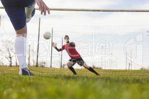 Goalkeeper in red saving a penalty