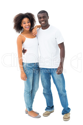 Casual couple in jeans and white tops smiling at camera