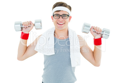 Geeky hipster lifting dumbbells in sportswear