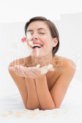 Beautiful happy woman with flower petals