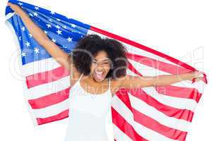 Pretty cheering girl in white top holding american flag