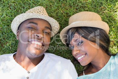 Happy couple lying in garden together