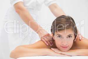 Attractive woman receiving shoulder massage at spa center