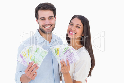 Happy couple showing their money