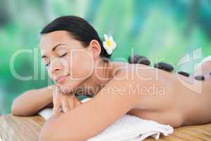 Beautiful brunette enjoying a hot stone massage