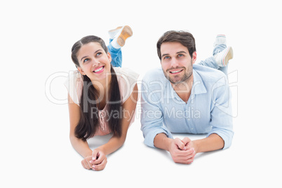 Attractive young couple smiling looking up