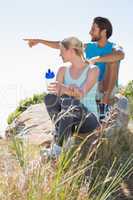 Fit couple taking a break at summit