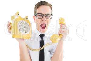 Geeky businessman shouting at retro phone