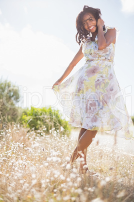 Beautiful woman in floral dress smiling at camera