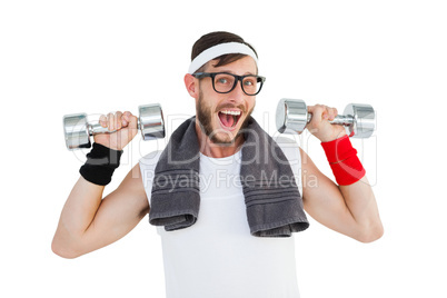 Geeky hipster lifting dumbbells in sportswear