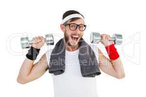 Geeky hipster lifting dumbbells in sportswear