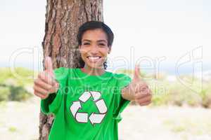 Pretty environmental activist smiling at camera showing thumbs u
