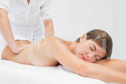 Attractive woman receiving back massage at spa center