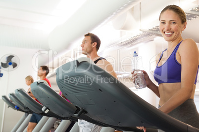 Row of people working out on treadmills