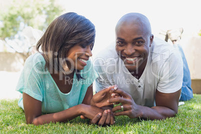 Happy couple lying in garden together