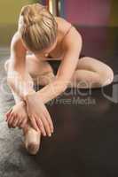 Ballerina sitting and bending forward