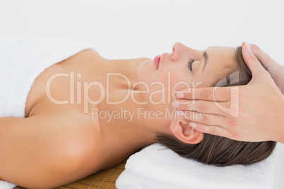 Attractive woman receiving head massage at spa center