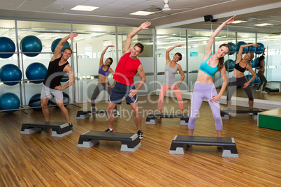 Fitness class doing step aerobics