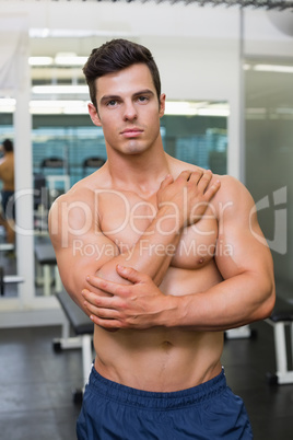 Muscular man posing in gym