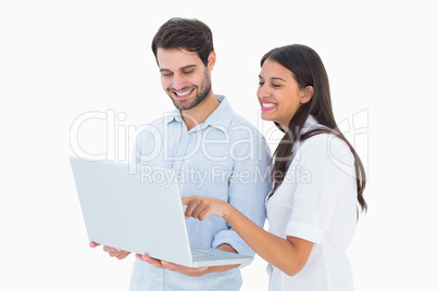 Attractive young couple holding their laptop