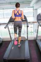 Fit brunette running on the treadmill