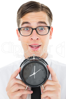 Geeky businessman holding alarm clock