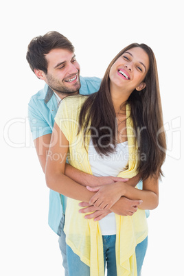 Happy casual couple smiling and hugging Happy casual couple smiling and hugging