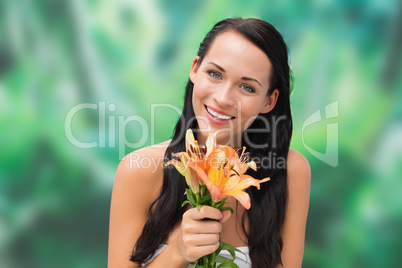 Beautiful nude brunette smelling bunch of lilies