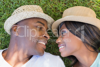 Happy couple lying in garden together