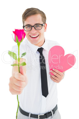 Geeky hipster holding a red rose and heart card