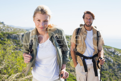 Attractive hiking couple walking on mountain trail