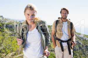 Attractive hiking couple walking on mountain trail