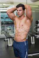 Muscular man looking away in gym