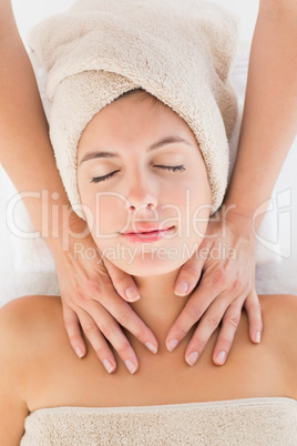 Attractive young woman receiving massage at spa center