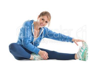 Happy young woman touching hand to leg