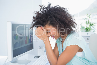 Casual businesswoman stressing out at her desk