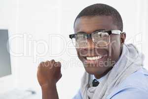 Hipster businessman smiling at his desk