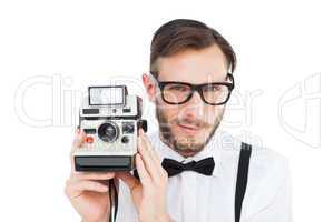 Geeky hipster holding a retro camera