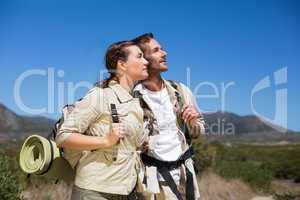 Hiking couple standing and looking on country terrain