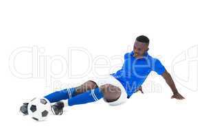 Football player in blue kicking