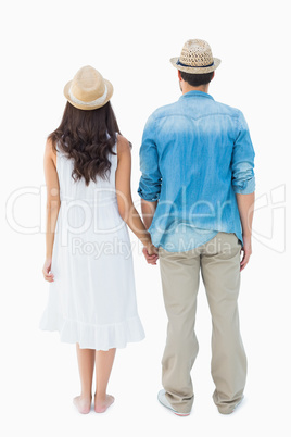 Happy hipster couple holding hands