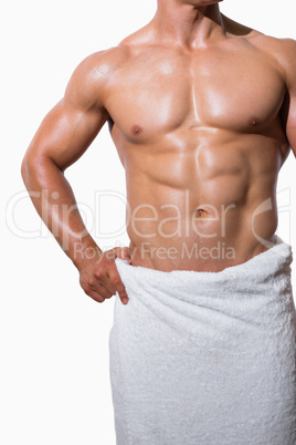 Mid section of a shirtless muscular man in white towel