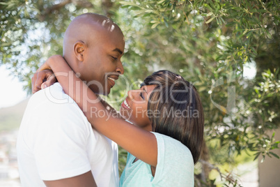 Happy couple hugging each other in garden Happy couple hugging each other in garden