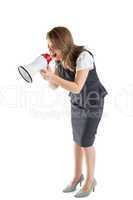 Young businesswoman shouting into bullhorn