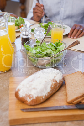 Family having lunch together of bread and salad