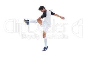 Football player in white kicking