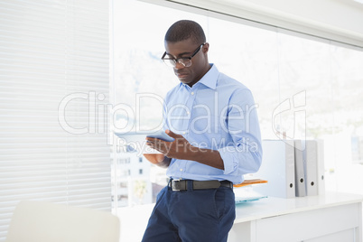 Happy businessman using his tablet pc