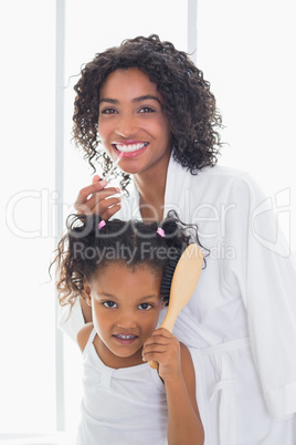 Pretty mother getting ready with her daughter